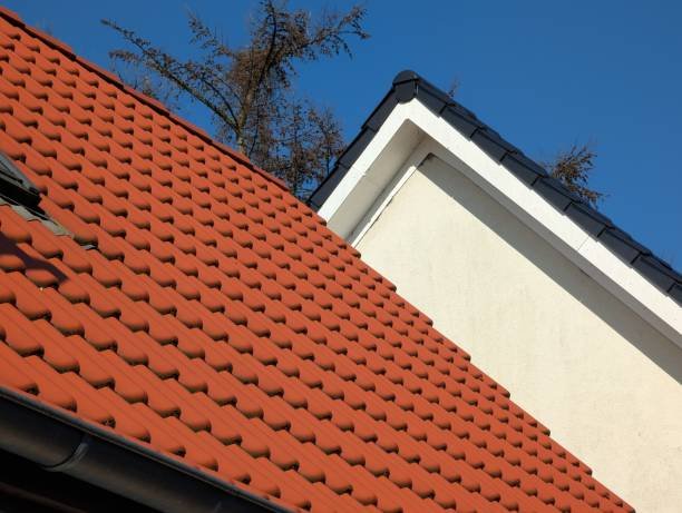 Close-up of a red tile roof, highlighting the texture and color of the tiles in relation to roofing styles.