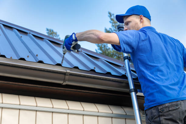 A man drills to install a metal roof, demonstrating the process of metal roofing installation.