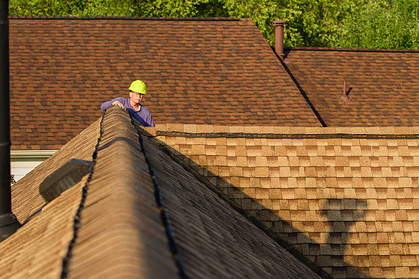 A man check safety vest examines a house's gutter, showcasing the work of Residential Roofing Experts.