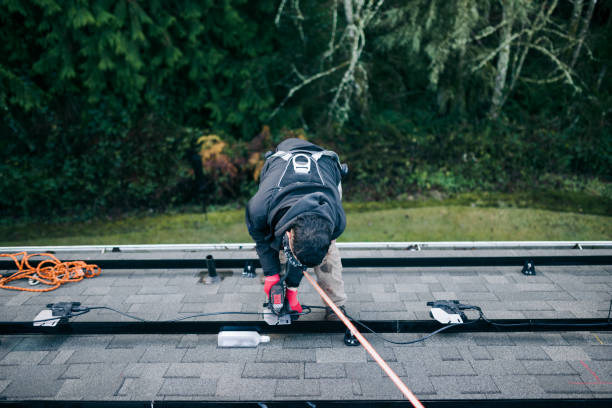 Two men working together on a house roof to address a leak repair.