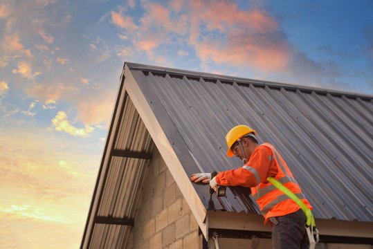 professional commercial roofing contractor checking roof drainage system