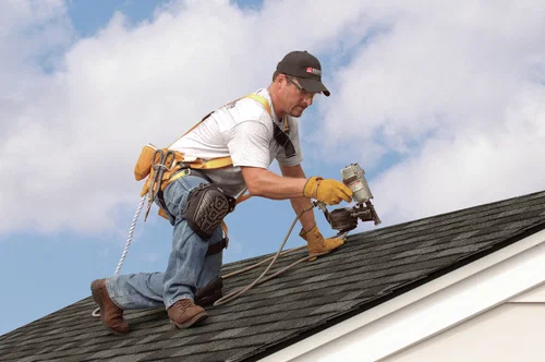 professional commercial roofing contractor examining roof flashing damage