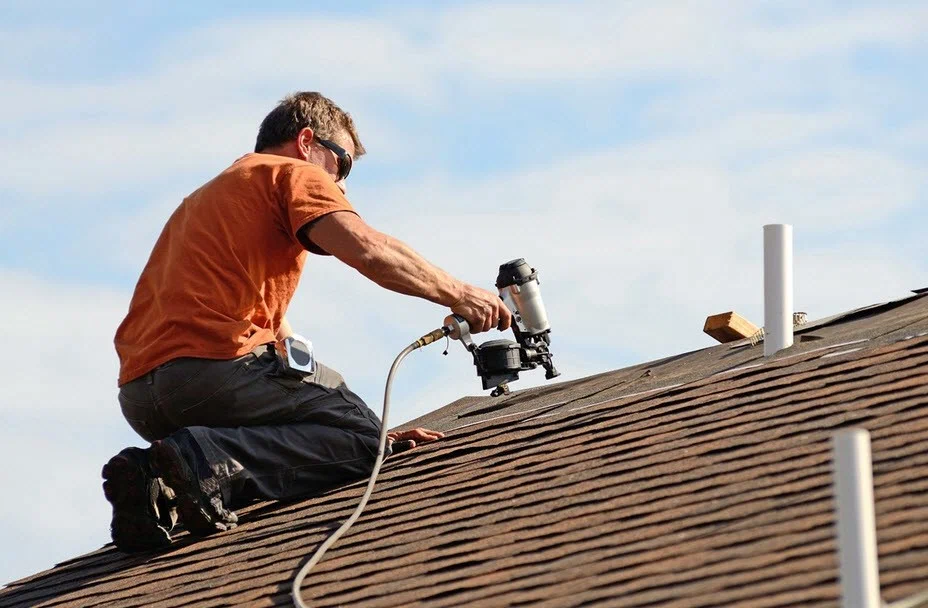 professional commercial roofing contractor evaluating roof membrane condition